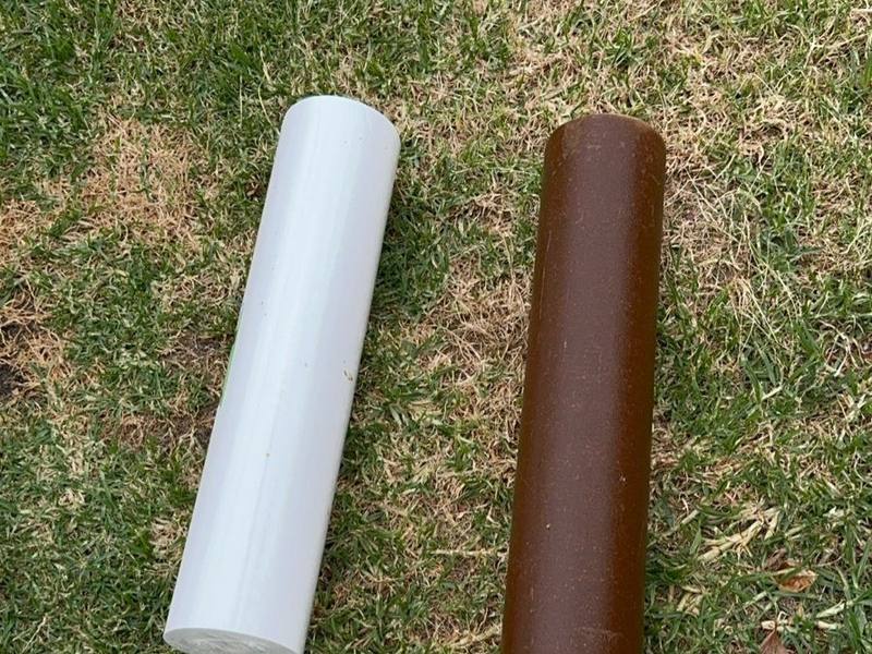 A new white filter cartridge beside a used brown one on the lawn
